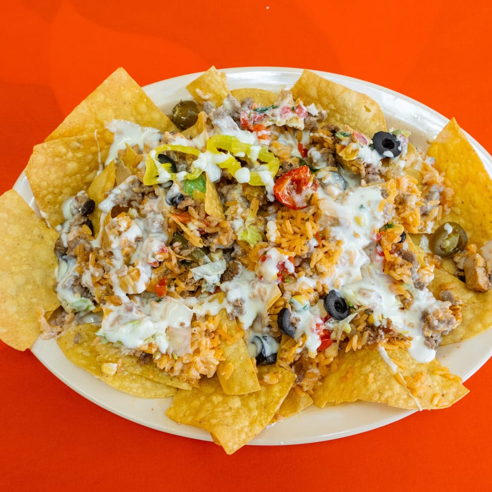 Loaded nachos with cheese and toppings.