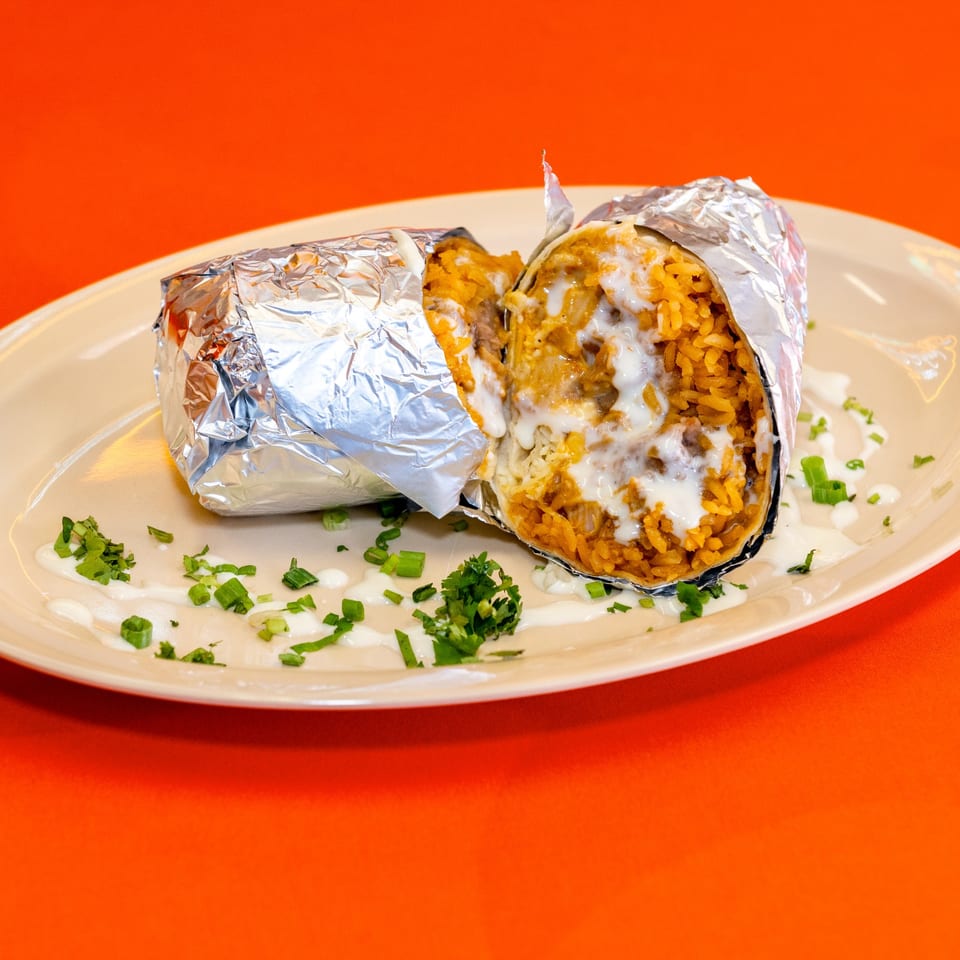 College Burrito cut open to show rice and filling.