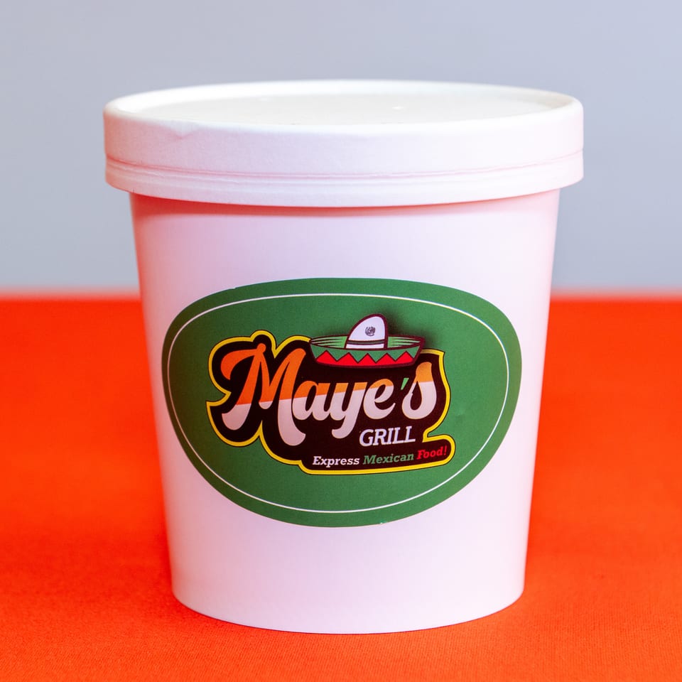 White takeaway cup featuring the green and colorful Maye’s Grill Express Mexican Food logo on a bright red surface.